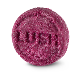 Lush's Jason and the Argan Oil shampoo bar. A round red bar stamped with "LUSH". Every surface is made up of tiny white sticks.